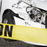 Damaged car behind caution tape: Lorenzo & Lorenzo Auto & Motorcycle Accident Blog