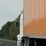 Orange semi-truck on highway: Lorenzo & Lorenzo Auto & Motorcycle Accidents Blog