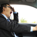 man yawning behind the wheel: Lorenzo Auto & Motorcycle Accident Blog