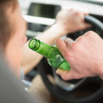 Driver holding beer bottle in car: Lorenzo & Lorenzo Auto & Motorcycle Accidents Blog