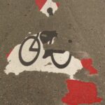 fading bicycle sign on street: Lorenzo Personal Injury Blog